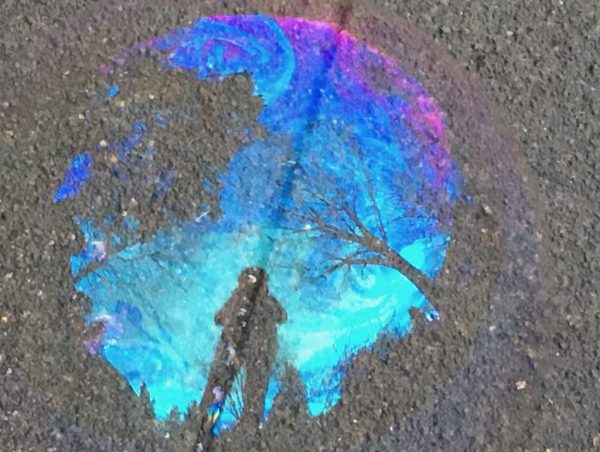 Misty Post reflection in bubble on sidewalk